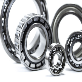 Close up of five different sized bearings isolated on a white background.